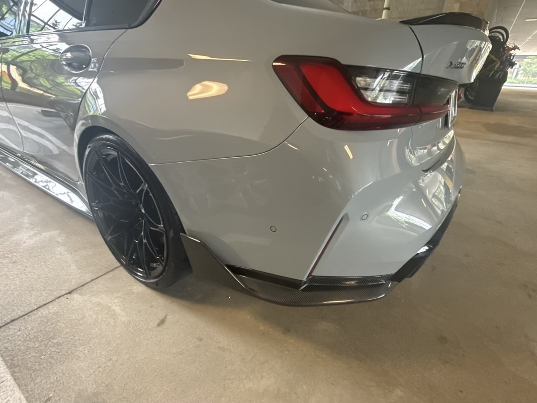 2024 BMW M3 rear corner with carbon diffuser and taillights