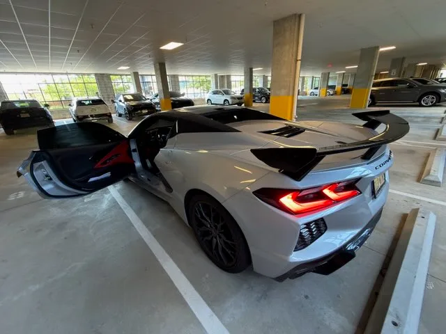 Corvette C8 Stingray rear with high wing and taillights lit