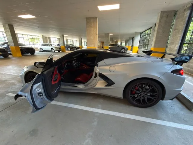 Corvette C8 Stingray side profile with door open showing red interior