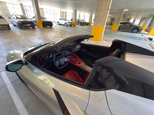 Corvette C8 Stingray convertible with top down and red seats